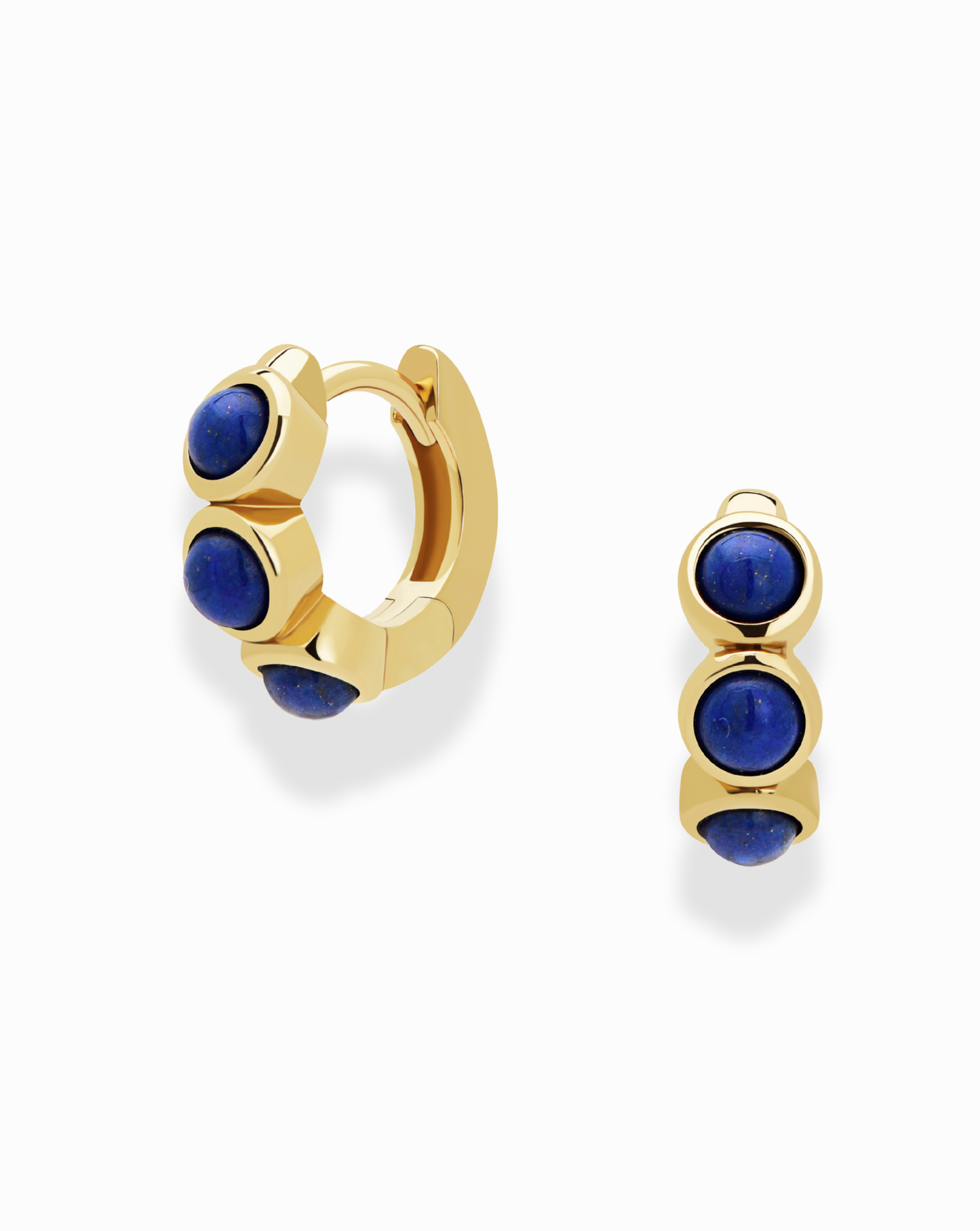 The Corynn Gemstone Huggies by Mod + Jo are 18k gold plated earrings, each set with three vertical round deep blue natural lapis lazuli stones, shown on a plain white background.