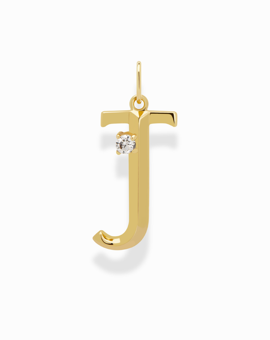 The Eloise Letter Charm by Mod + Jo is a gold, lowercase "j"-shaped charm with a sparkling cubic zirconia on its upper curve, shown against a plain white background.