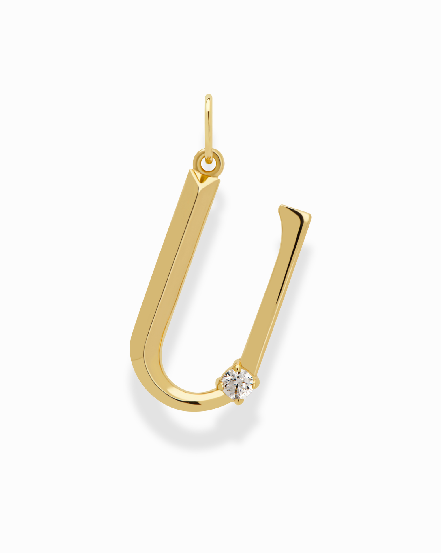 The Eloise Letter Charm by Mod + Jo is an 18k gold plated "U"-shaped pendant with a small round diamond at the base, shown on a white background.