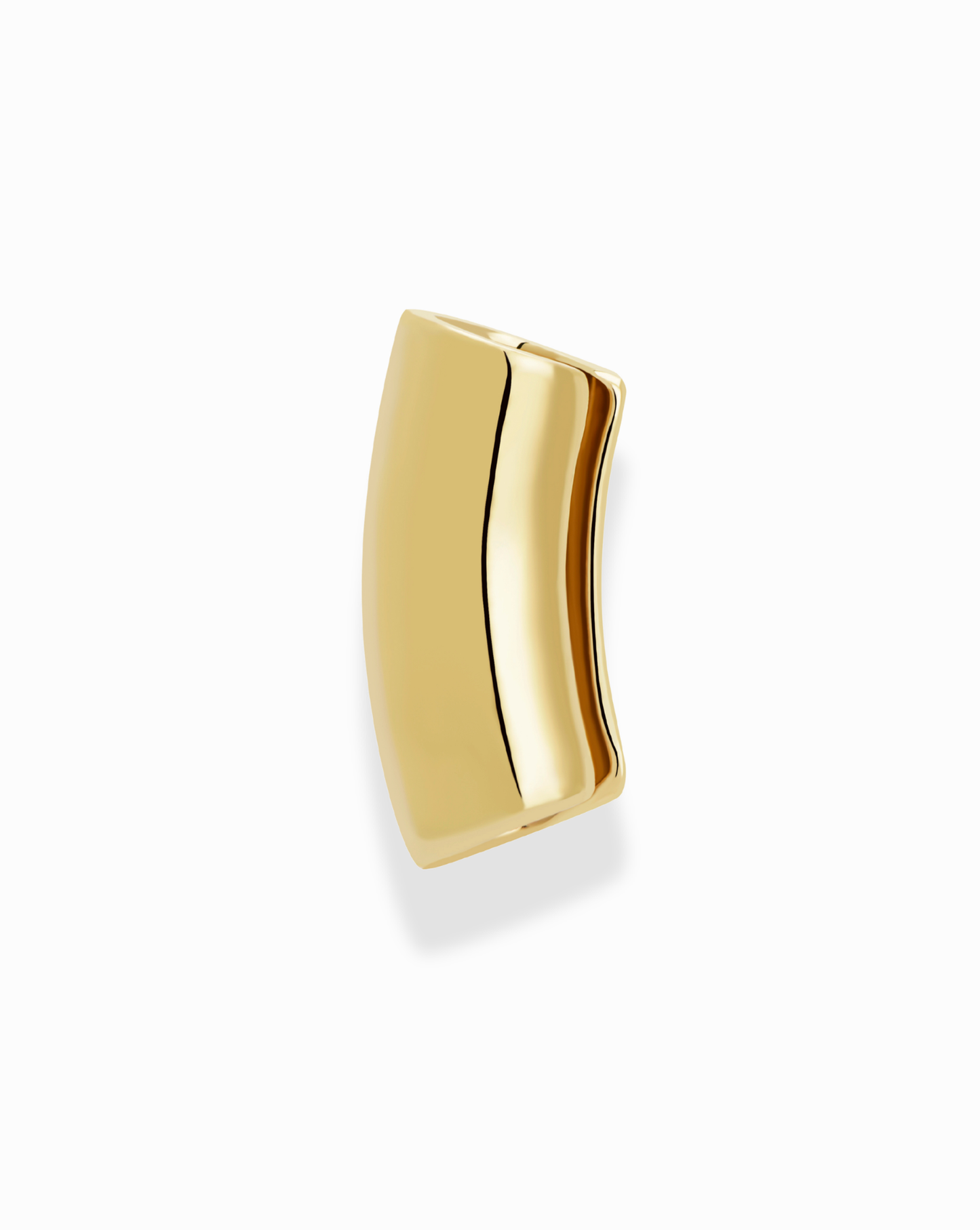The Mod + Jo Lennon Tube Helix Ear Cuff is a shiny, curved rectangular piece with smooth edges, plated in 18k gold. Shown on a white background, it casts a soft shadow to the left.