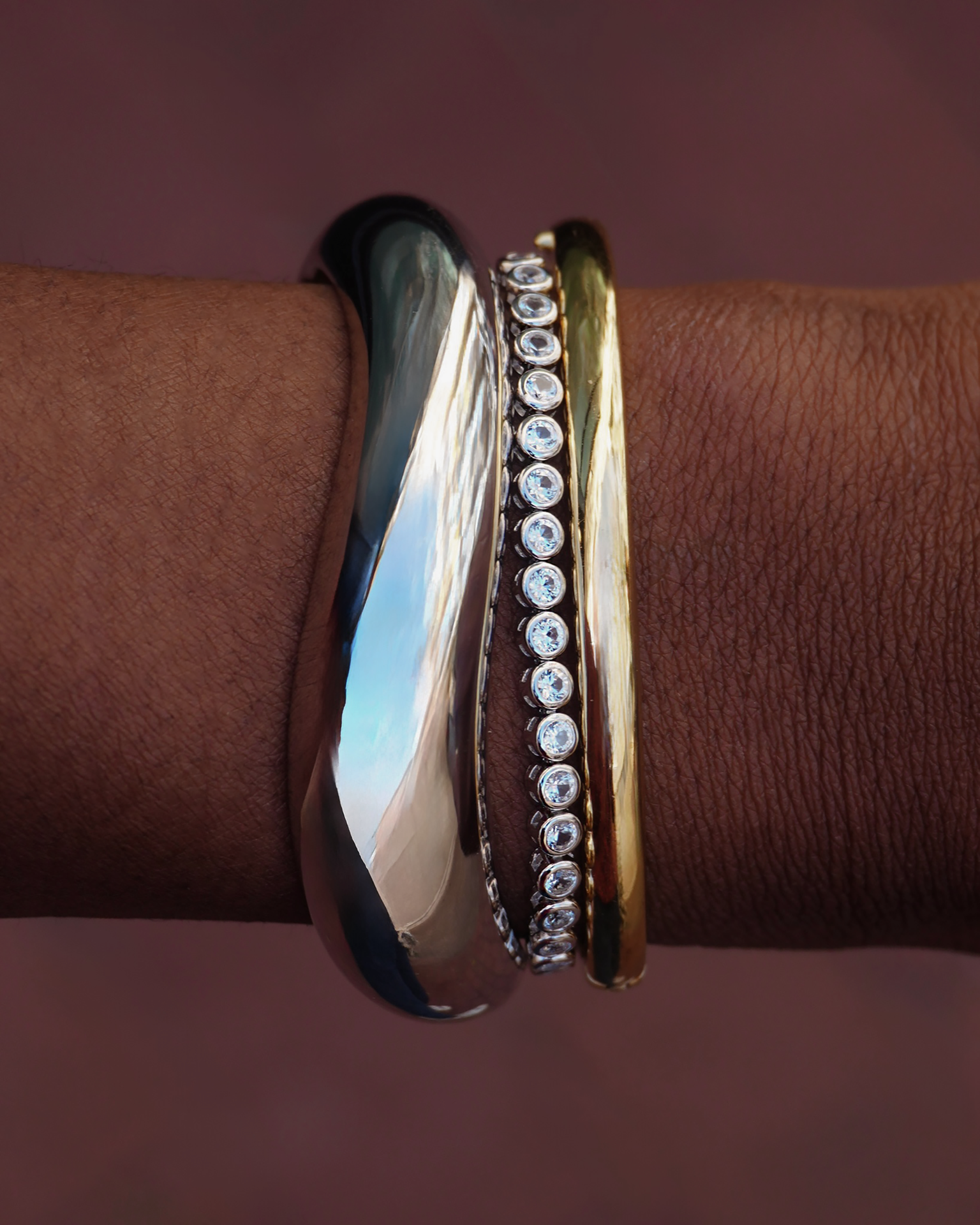 Emma Bezel Tennis Bracelet on wrist, showcasing the stylish gold, silver, and gemstone design.