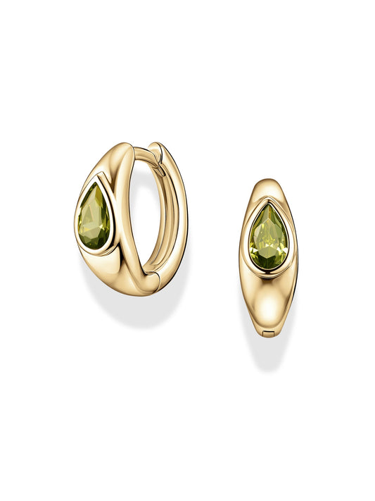 Tally Pear Huggie Hoops by Mod + Jo featuring teardrop-shaped green CZ gemstones set in the center of gold plated hoops, displayed on a white background. These stylish earrings are nickel-free for comfortable wear.