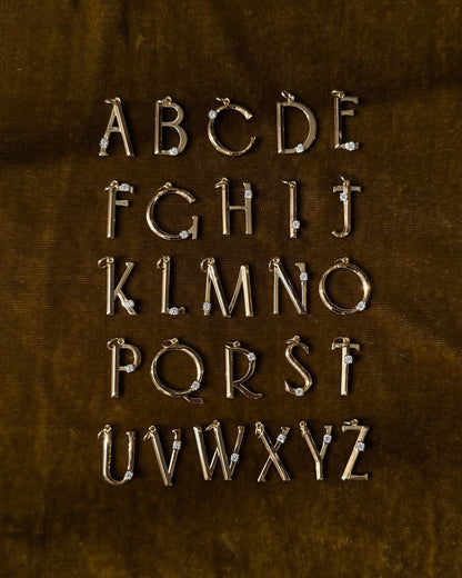 The Eloise Letter Charm by Mod + Jo features gold alphabet pendants with sparkling cubic zirconia in four rows, displaying A to Z—perfect as a gold initial necklace or letter charm for any style.