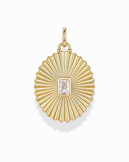 The Cora Fluted Charm by Mod + Jo showcases a radiant sunburst design, featuring an emerald-cut crystal at its center. Crafted in 14k gold, the pendant's ribbed detailing and top loop make it an elegant addition to any necklace.