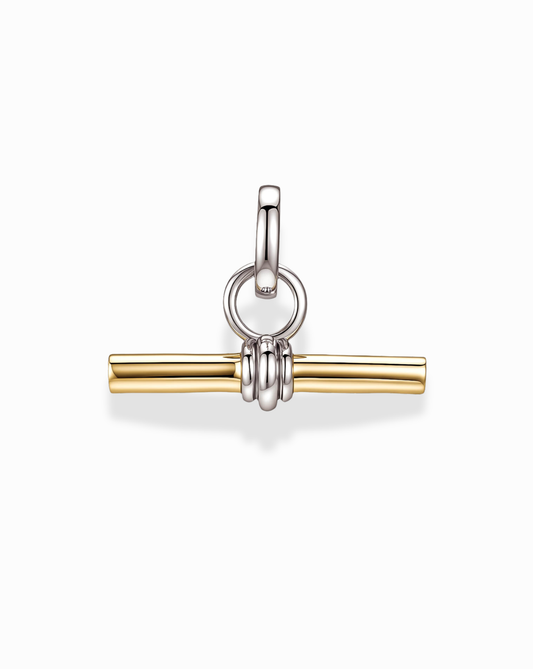 The Elliot Toggle Charm by Mod + Jo is a gold-plated bar pendant displayed on a white background, accented with a silver ring and bail. Three silver loops hold the bar at the center, highlighting its modern and minimalist jewelry design.