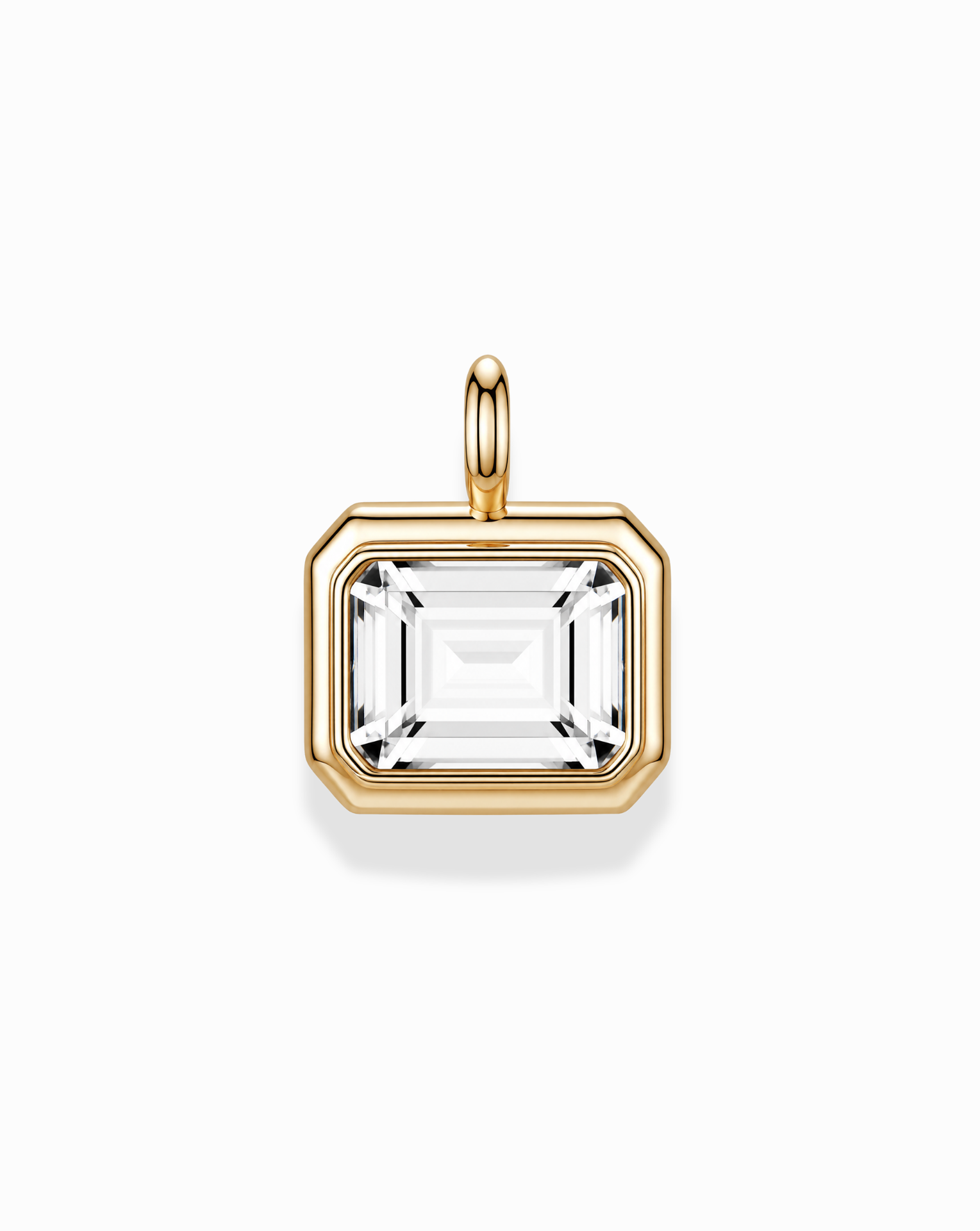 The Elsie Sapphire Bezel Charm by Mod + Jo features a rectangular, emerald cut lab-grown white sapphire set in a 14k gold bezel with a gold bail, showcased on a white background.