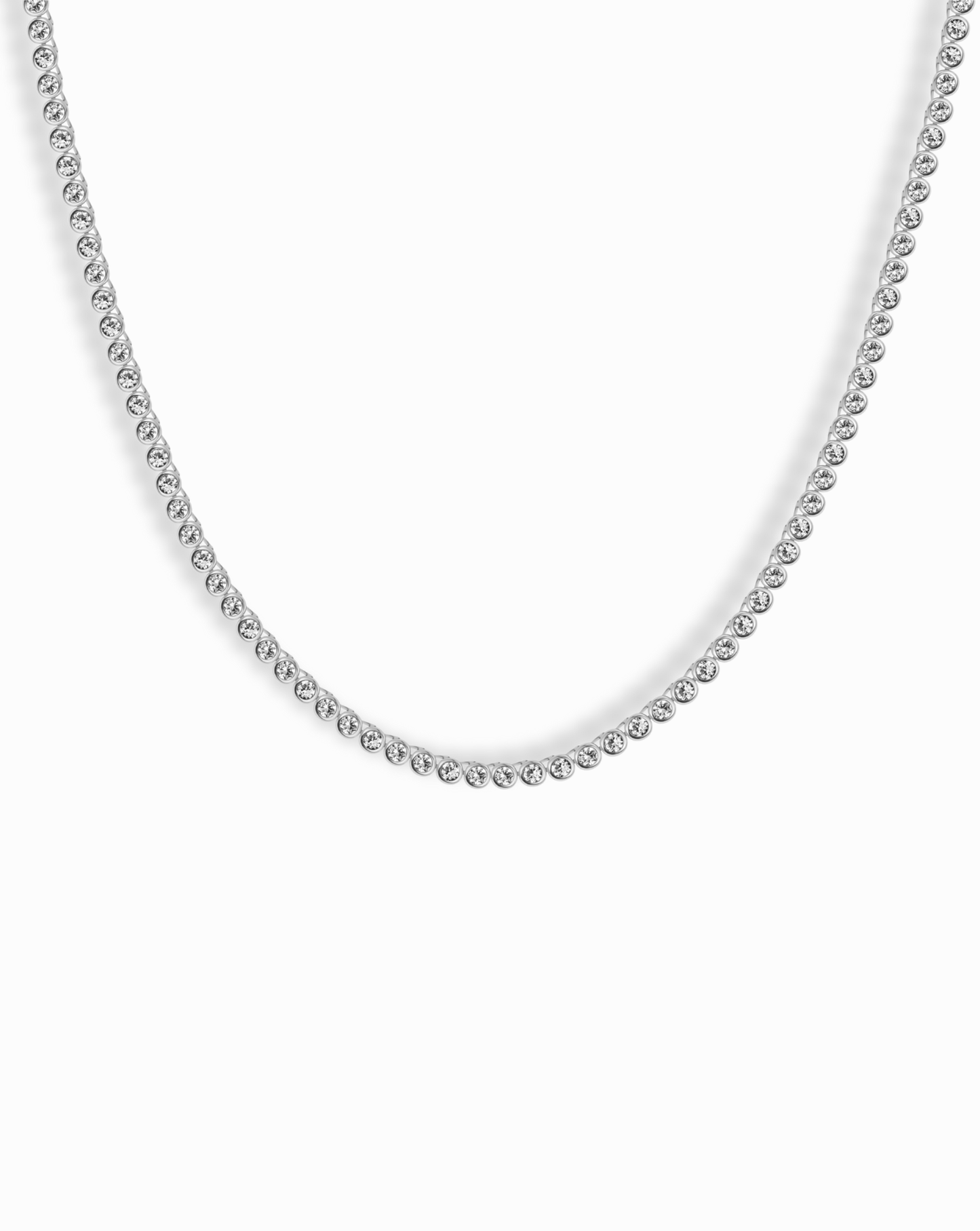Close-up of Emma Bezel Tennis Necklace displaying its delicate diamond bezel setting and simple elegance.