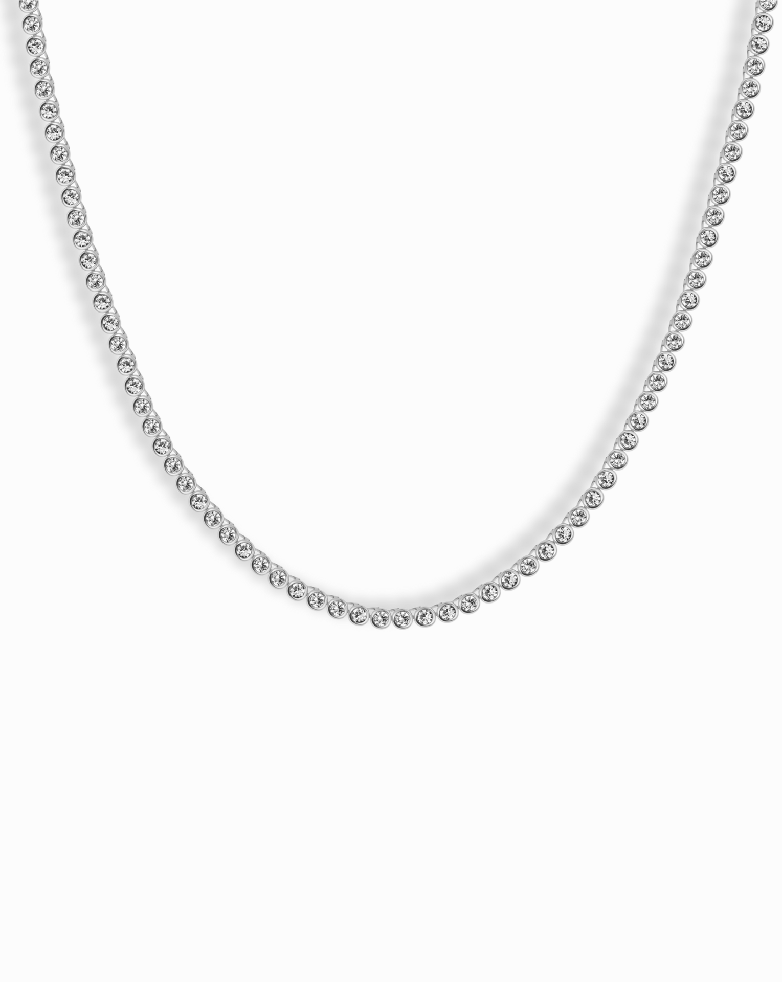 Close-up of Emma Bezel Tennis Necklace displaying its delicate diamond bezel setting and simple elegance.