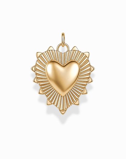 The Grande Lynn Engravable Heart Charm by Mod + Jo features a gold heart pendant with a raised center and a radiating sunburst pattern along the edges, expertly crafted in 14k gold over brass. Photographed on a white background, this customizable piece brings a timeless touch to any jewelry collection.