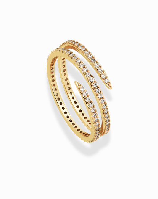 Golden spiral ring with pave diamonds. Jewelry product detail shot showcasing its design.