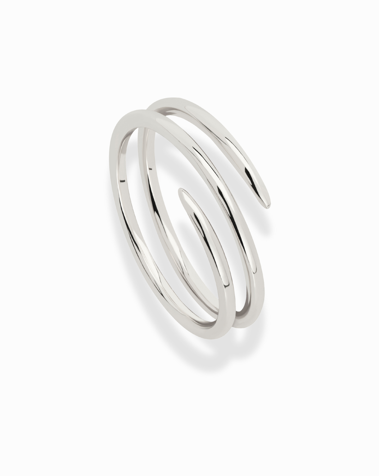 The Greer Spiral Ring features a shiny silver, minimalist design with two smooth, open-ended coils. This stackable ring is spiral-shaped and photographed on a white background.