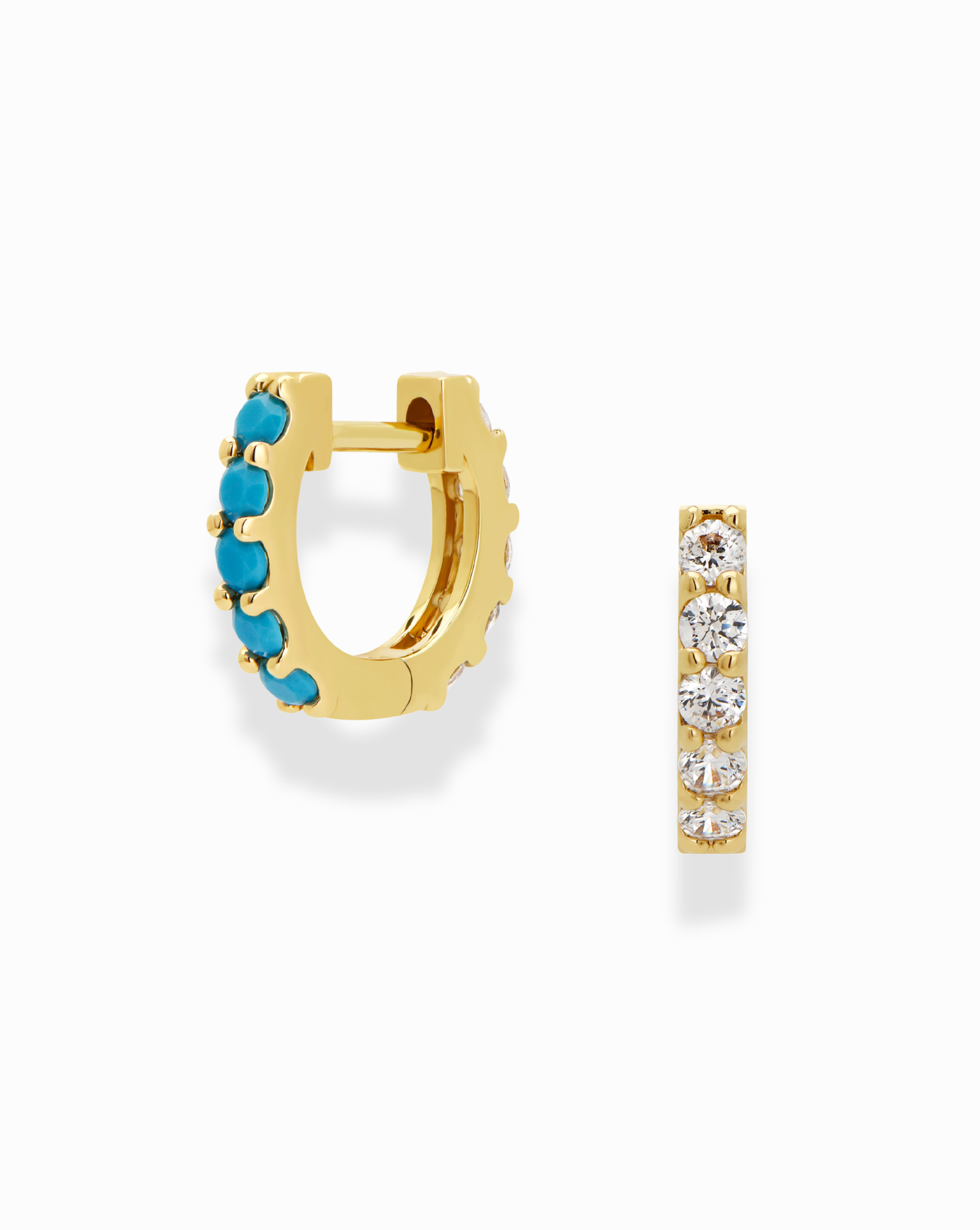 The Harlow Reversible Birthstone Huggies by Mod + Jo feature one gold-plated hoop with turquoise stones and the other with clear crystals, elegantly displayed on a white background.
