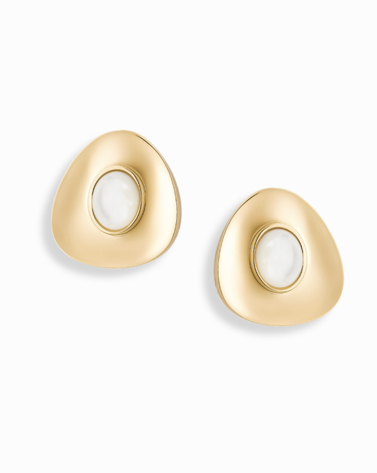 The Hunter Statement Studs by Mod + Jo are 14k gold, irregularly-shaped earrings with a white circular stone at the center, shown on a white background.