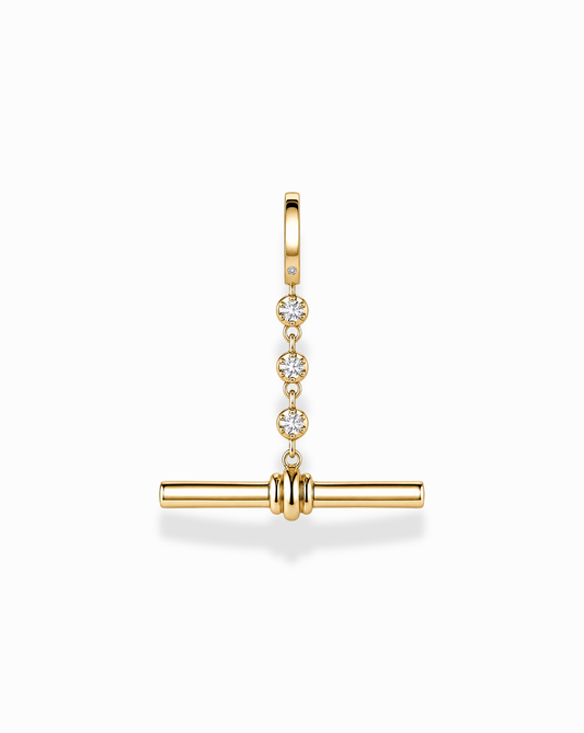 The Mod + Jo Livia Tennis Toggle Charm is a gold-plated jewelry pendant featuring three small diamonds set vertically, with a horizontal gold bar suspended below, shown against a white background.