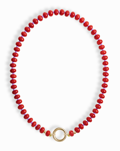 The Macey Gemstone Necklace by Mod + Jo showcases bright red, round genuine gemstones in a single strand with a bold circular gold clasp at the center.