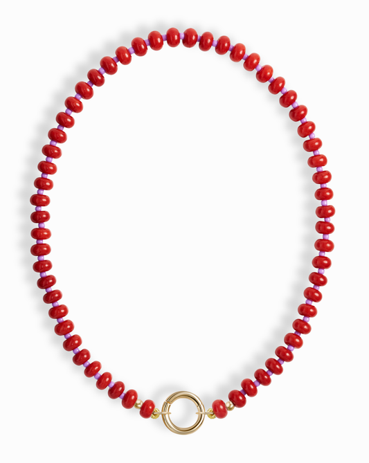 The Macey Gemstone Necklace by Mod + Jo showcases bright red, round genuine gemstones in a single strand with a bold circular gold clasp at the center.