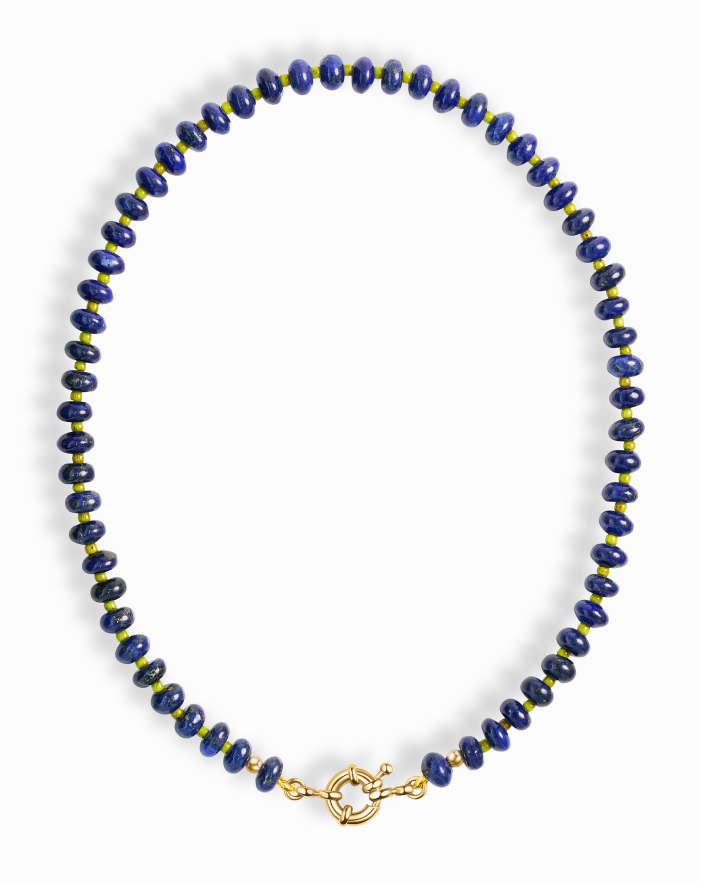 The Mod + Jo Macey Gemstone Necklace features round, deep blue lapis lazuli beads separated by small gold accents and finished with a circular gold clasp, arranged in an oval shape against a white background.