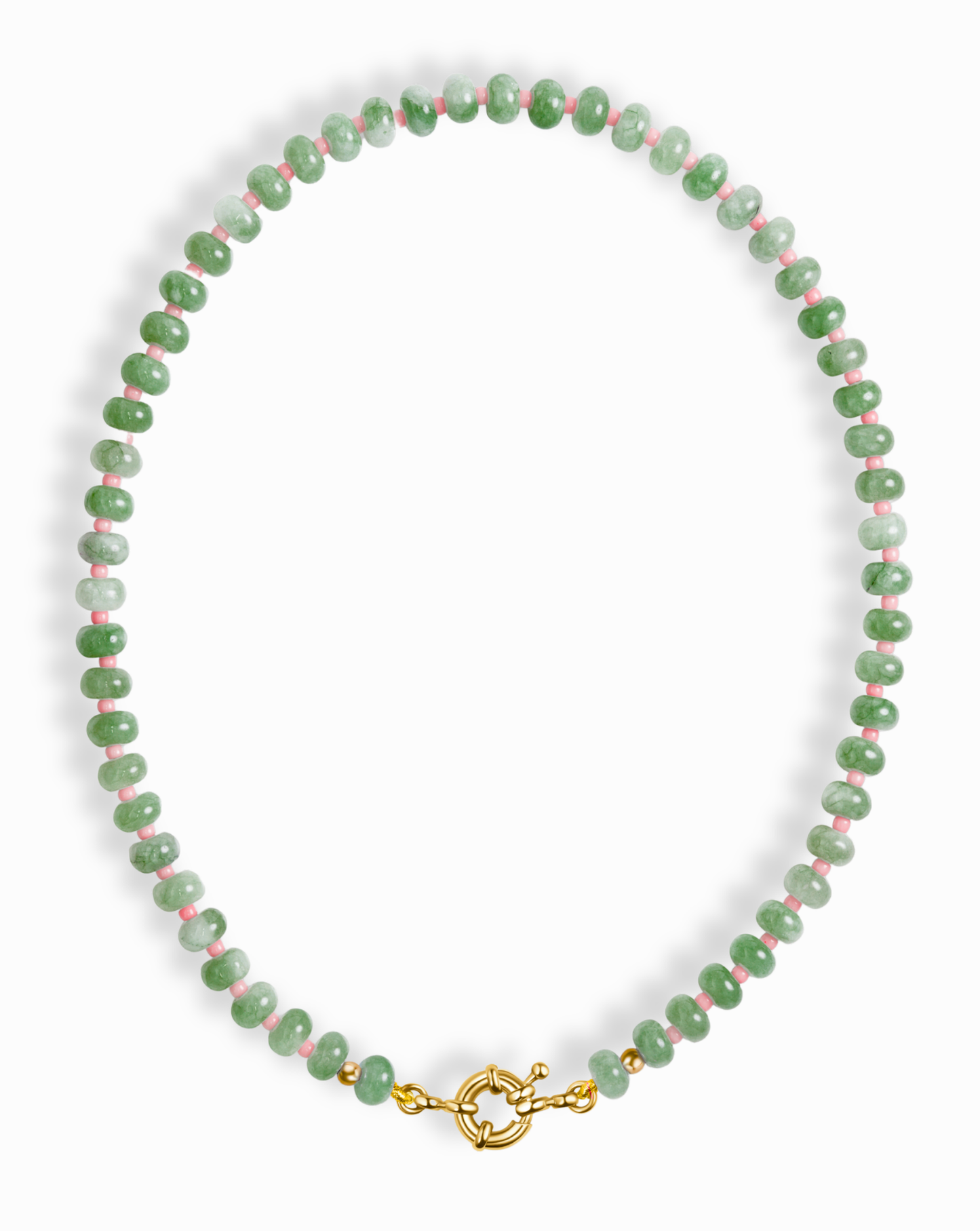 The Mod + Jo Macey Gemstone Necklace showcases round green jade, white beads, and small red accents, finished with a gold clasp. Displayed in a circular arrangement on a white background.