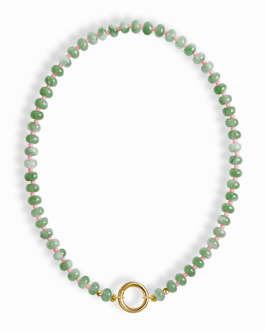 The Macey Gemstone Necklace by Mod + Jo features green jade and pink marbled beads with gold accents and a round gold clasp at the center.