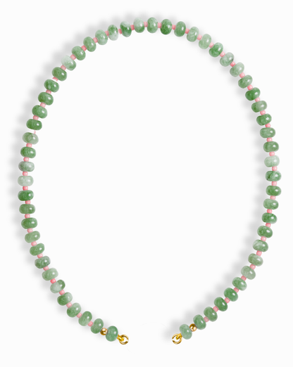 The Mod + Jo Macey Gemstone Necklace features round green jade beads with touches of white and pink, strung together and finished with gold clasps, shown on a white background.