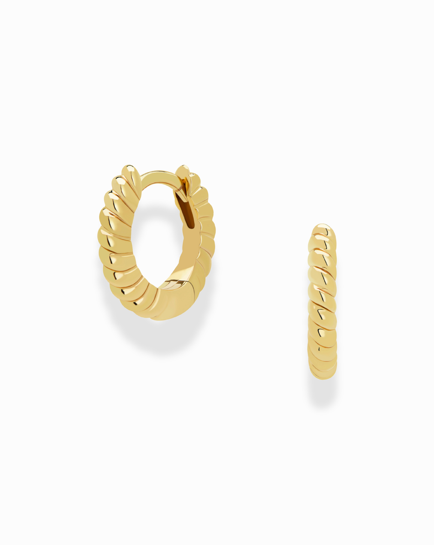 The Petite Margaux Stacking Hoops by Mod + Jo are small gold, tarnish-resistant earrings with a twisted, ridged design, shown on a white background—one hoop faces forward while the other is displayed in profile.