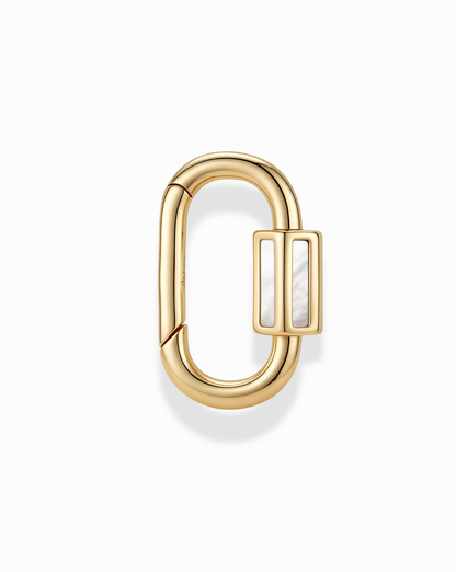 The Nora Lock Carabiner by Mod + Jo features a gold, oval-shaped clasp adorned with a rectangular accent and two white iridescent inlays, all elegantly finished with 14k plating and showcased against a plain white background.