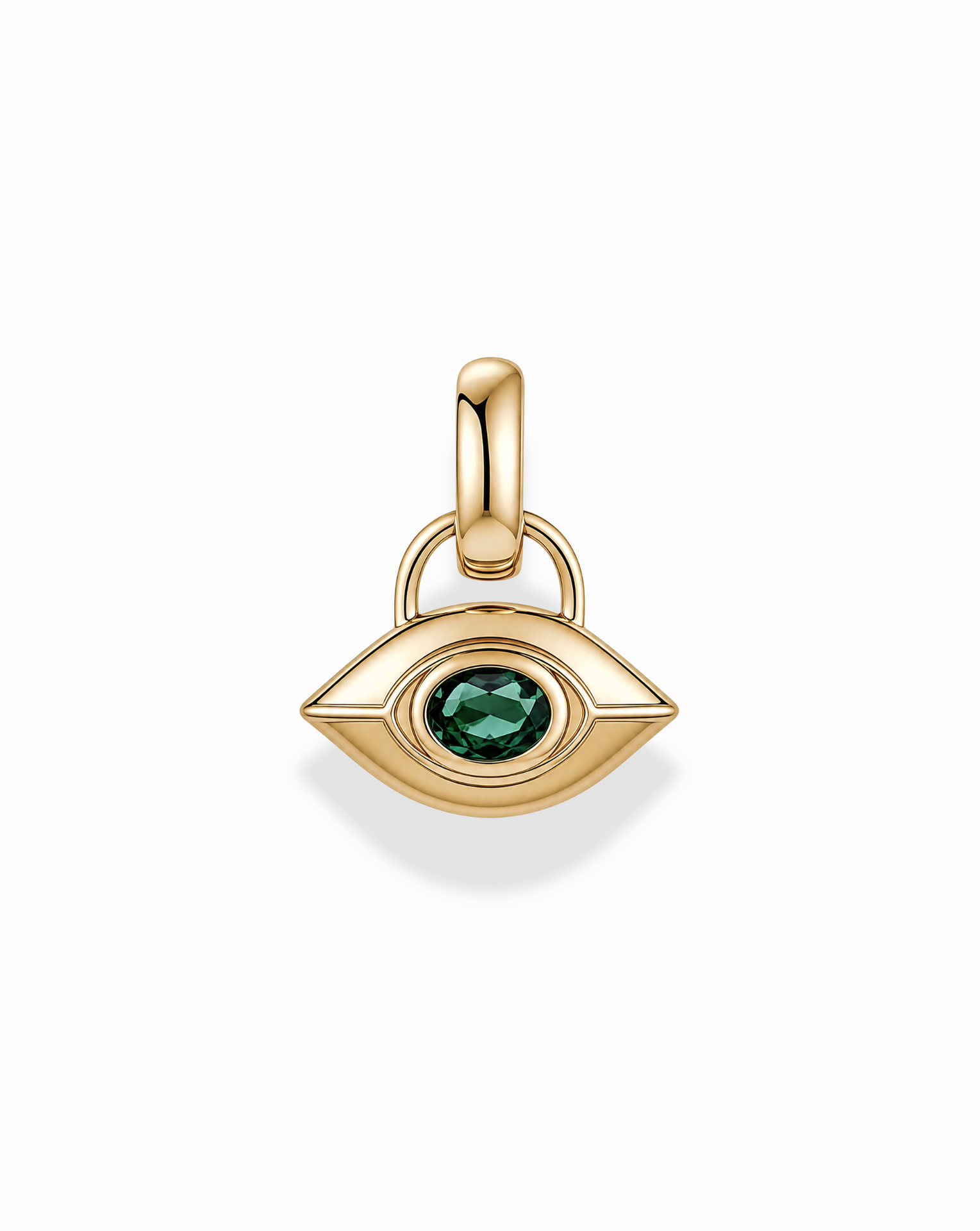 The Mod + Jo Nyx Evil Eye Charm is a gold, eye-shaped pendant featuring a green gemstone at its center, designed with a smooth finish and an attachment loop, shown against a white background.