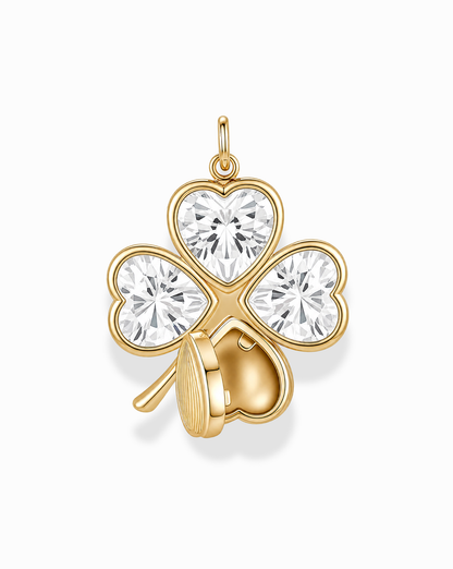 The Perry Four-Leaf Clover Locket Charm by Mod + Jo features a gold clover design, with each leaf crafted from heart-cut CZ crystals and one leaf partially adorned by a delicate gold heart.