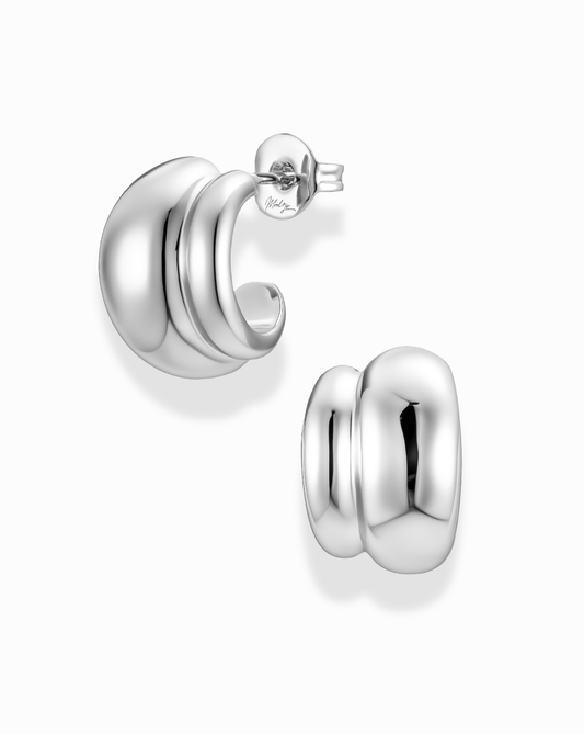 silver double dome hoop earrings on a white background