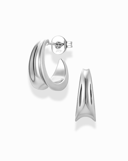 Gold inverted knife edge hoop earrings on a white background