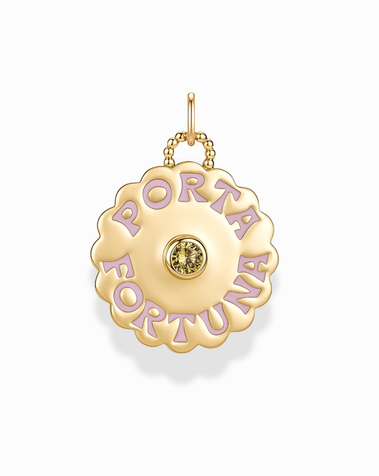 Introducing the Porta Fortuna Charm by Mod + Jo—a 14k gold pendant designed in a scalloped disc shape, highlighted by a central yellow gemstone and encircled with the phrase "PORTA FORTUNA" in delicate lavender lettering. This elegant piece is perfect as a lucky charm or a sophisticated gold coin necklace for any occasion.