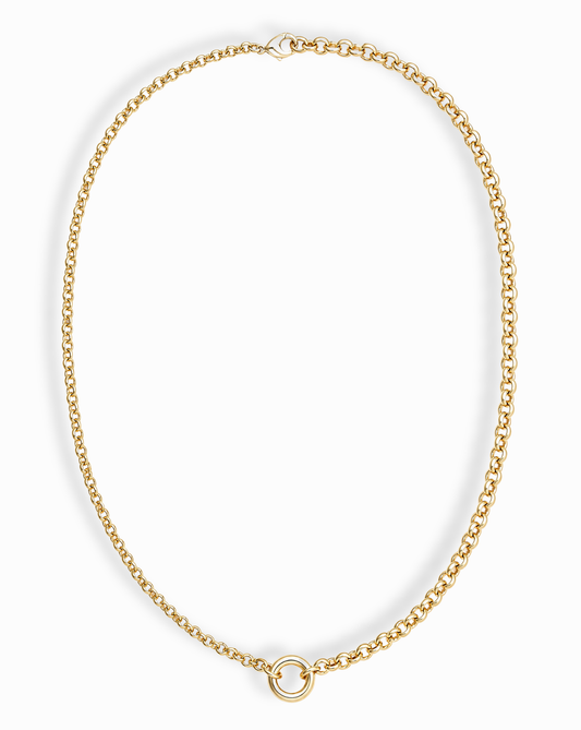 The Nessa Charm Clip Necklace by Mod + Jo is a 14k gold plated piece with interlocking links and a single round loop pendant at the center, shown against a white background.
