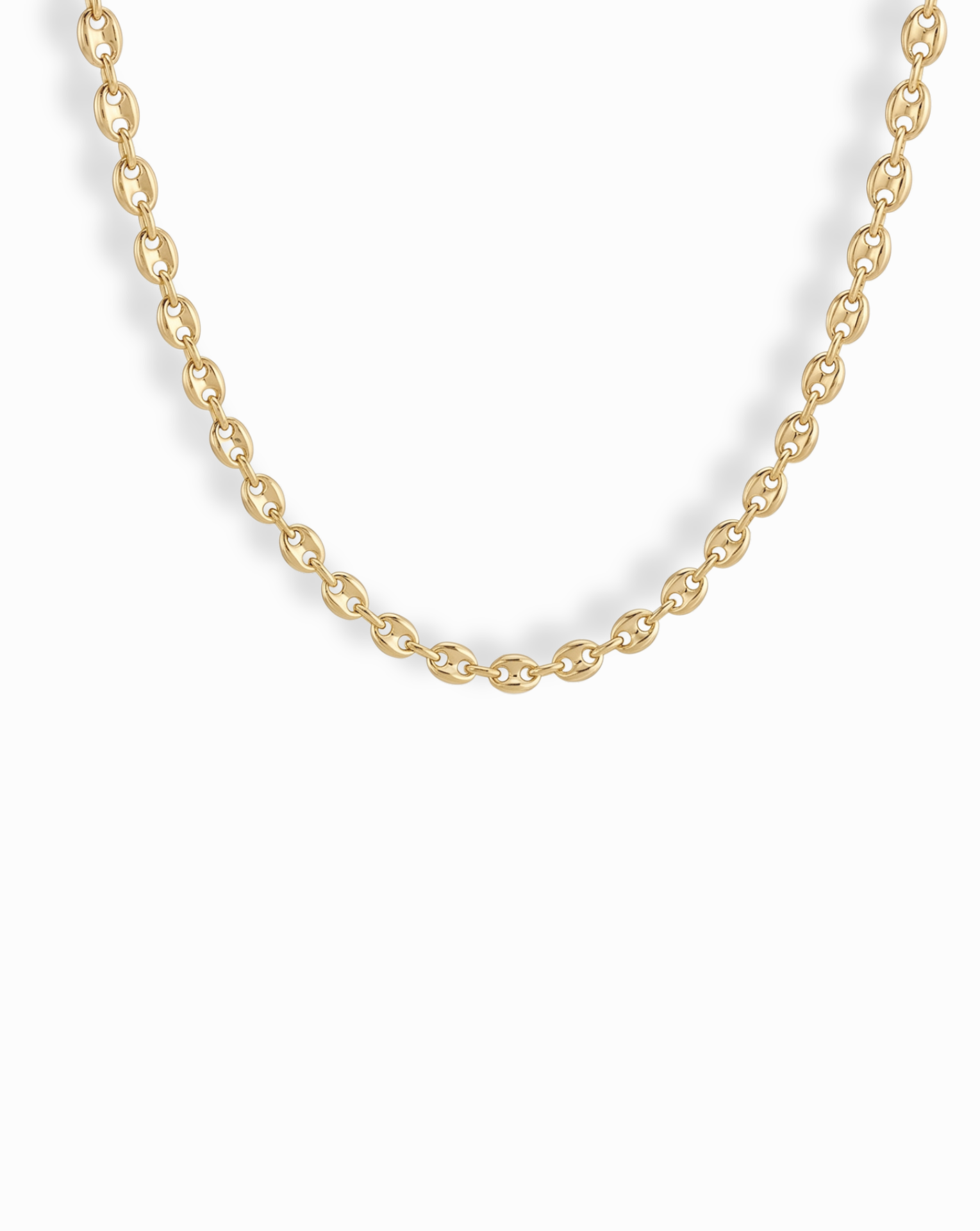 A close-up of the Mod + Jo Romee Puffy Mariner Necklace, featuring elegant oval links in 14k gold. The partially shown chain forms a gentle curve against a white background, highlighting its refined anchor link design.