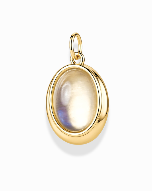 The Rory Gemstone Charm by Mod + Jo features a luminous oval moonstone gemstone with a subtle iridescent sheen, set in a smooth, polished gold frame and attached to a small gold loop for easy pairing with your favorite chain. This elegant charm captures timeless beauty and understated sophistication.
