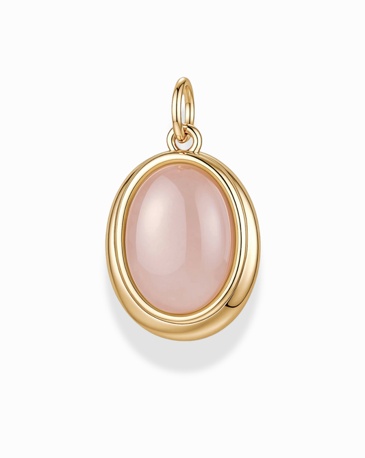 The Rory Gemstone Charm by Mod + Jo features an oval-shaped, polished Rose Quartz gemstone set at the center, symbolizing self-love, and hangs from a small 14k gold loop against a white background.