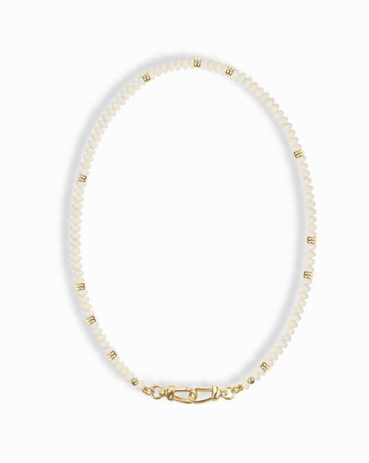 Close-up of the Sonia Gemstone Necklace, featuring delicate white beads and gold accents, highlighting its elegant design.