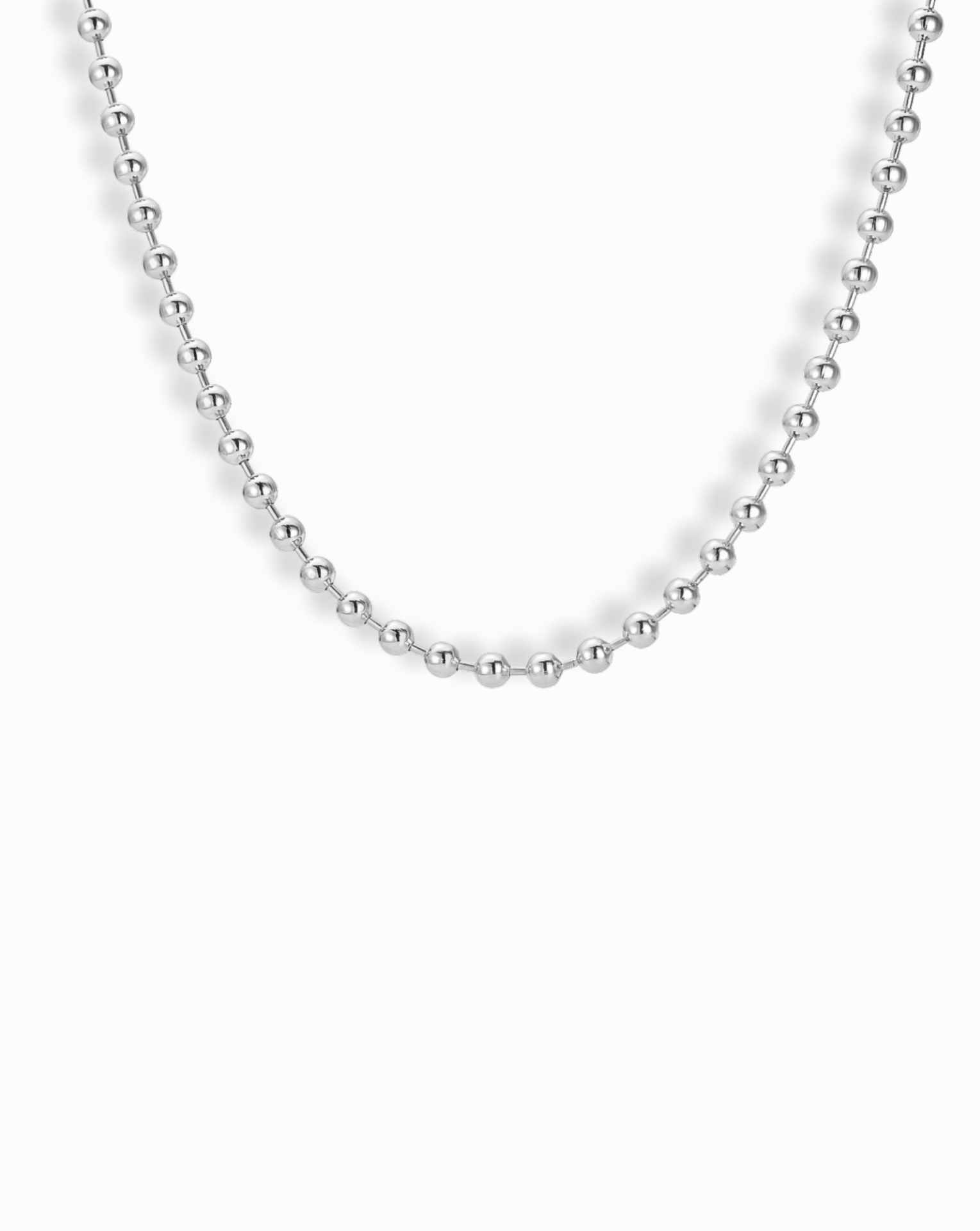 Silver ball chain necklace on a white background
