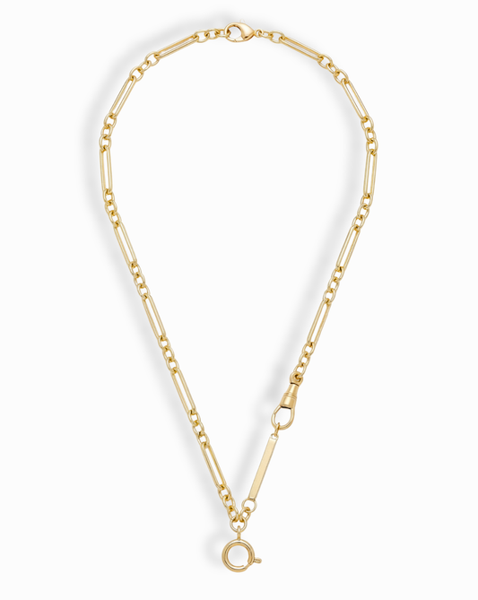 The Liam Space Bar Chain Necklace by Mod + Jo features a 14k gold-plated elongated oval link design with a large round clasp at the bottom and a smaller side clasp, arranged in an open circle on a white background.
