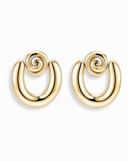 The Mod + Jo Sabine Statement Earrings are shiny 14k gold pieces with a bold, curved U-shape and spiral design at the top, shown against a plain white background.