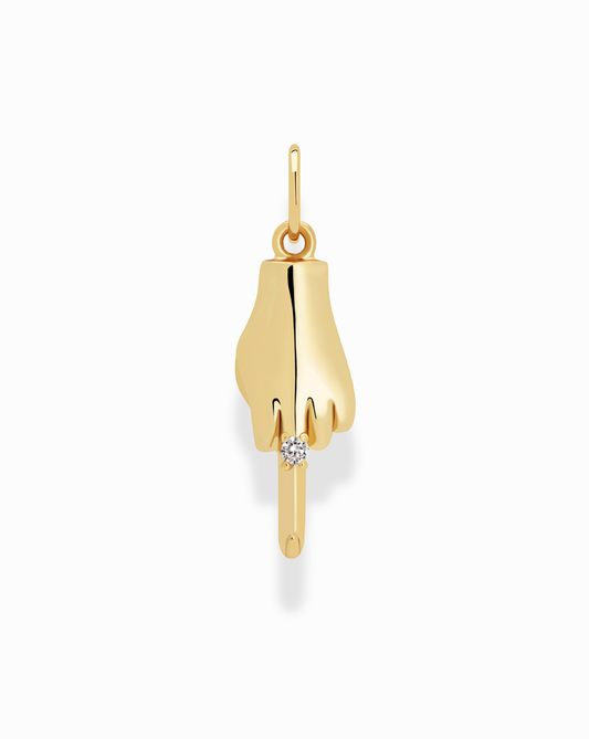 The Bird Charm by MOD + JO is a gold-plated pendant in the shape of a hand flipping the bird, featuring a small round white gemstone at the tip. It's lead-free and nickel-free, shown on a plain white background.