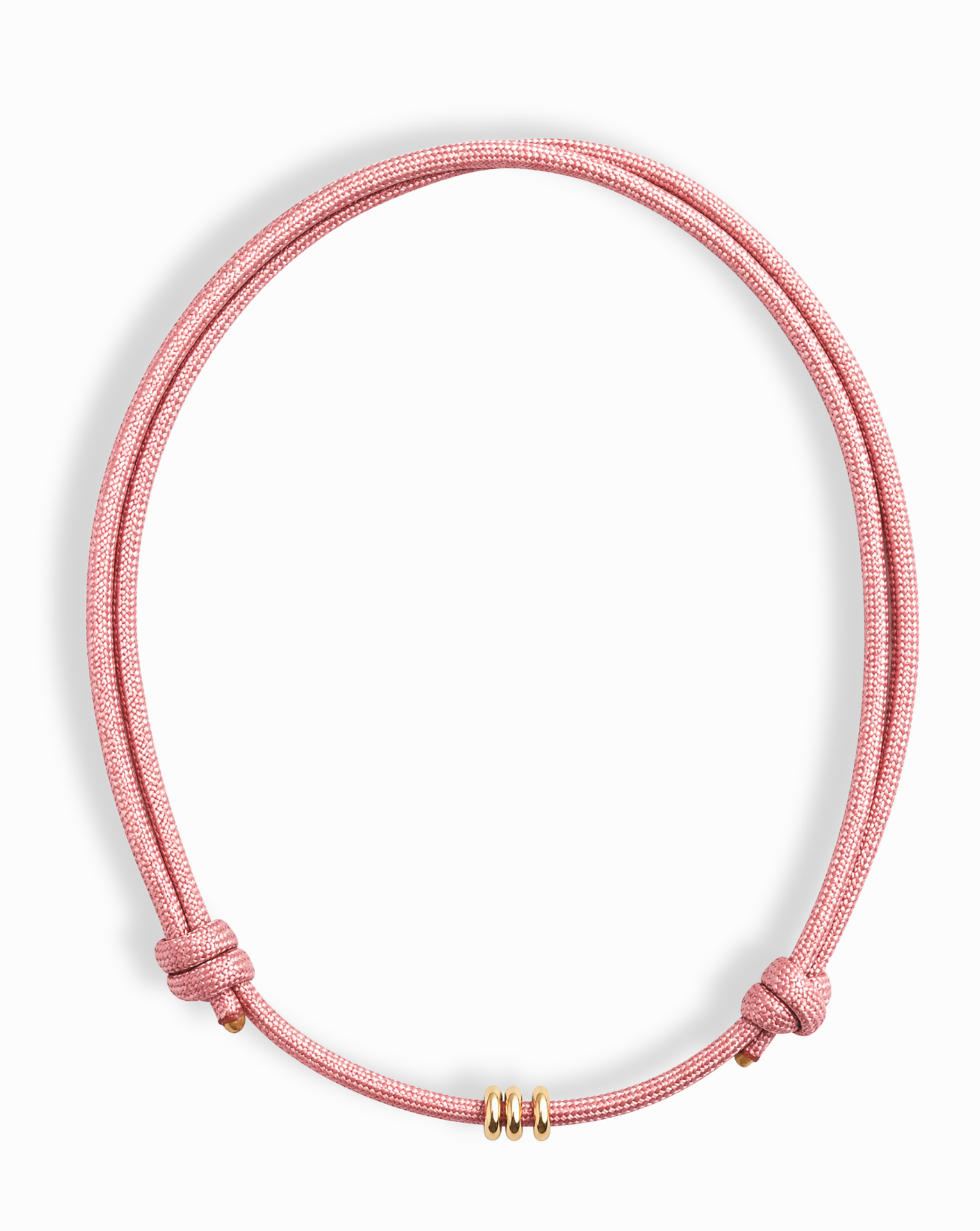 The Tommy Cord Necklace by Mod + Jo features a pink paracord with three gold-plated spacers at the front and adjustable side knots, shown against a white background.