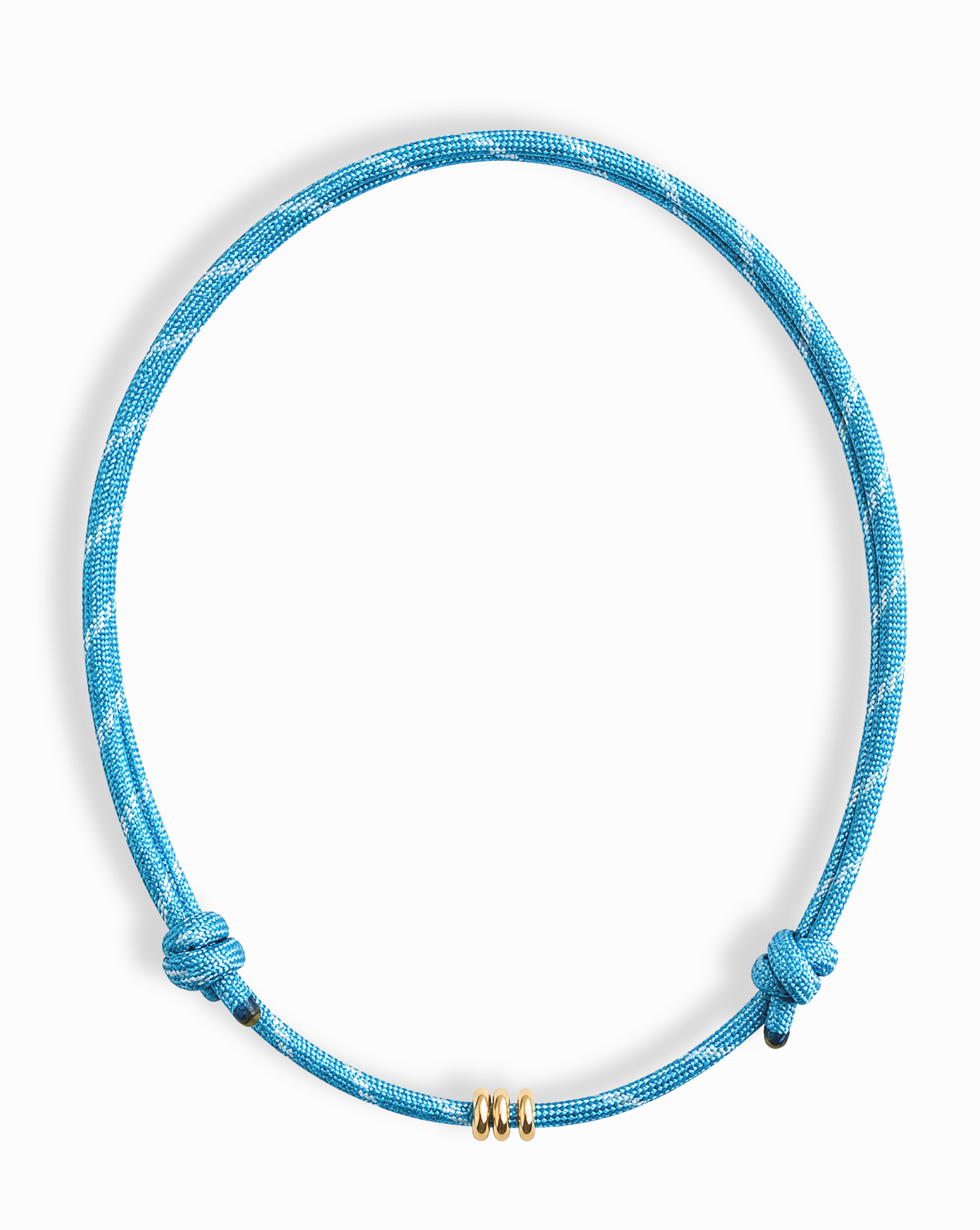 The Mod + Jo Tommy Cord Necklace is a blue paracord necklace with two side knots and three gold-plated spacers at the center, shown on a white background.