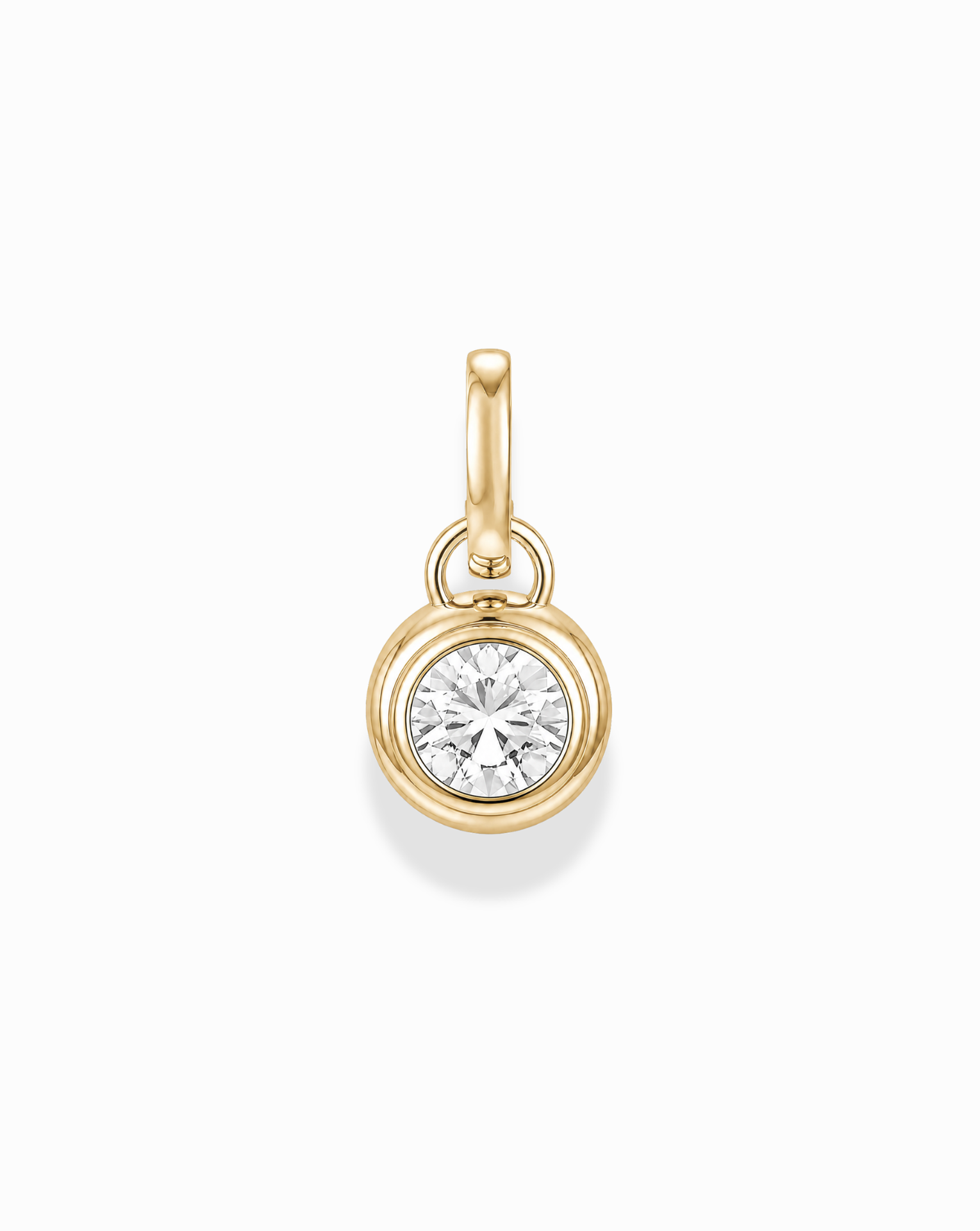 The Tove Sapphire Bezel Charm by Mod + Jo is a small 14k gold pendant featuring a round, clear lab-grown sapphire in a simple bezel setting with a gold loop, shown on a white background.