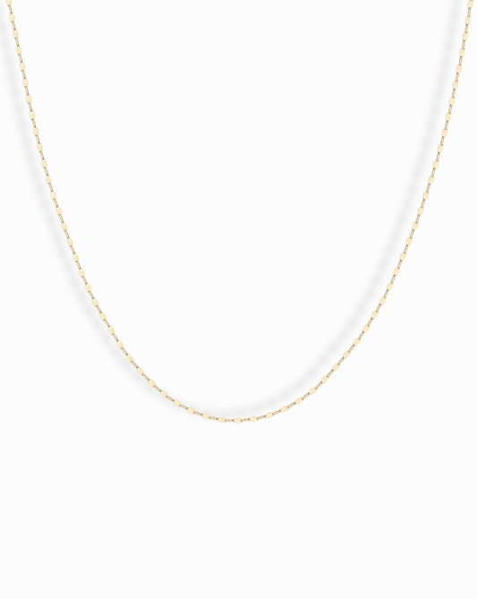 The Winnie Sparkle Chain Necklace features a delicate gold-filled chain with small, evenly spaced oval links for a subtle, elegant look—ideal for layering and displayed beautifully against a white background.